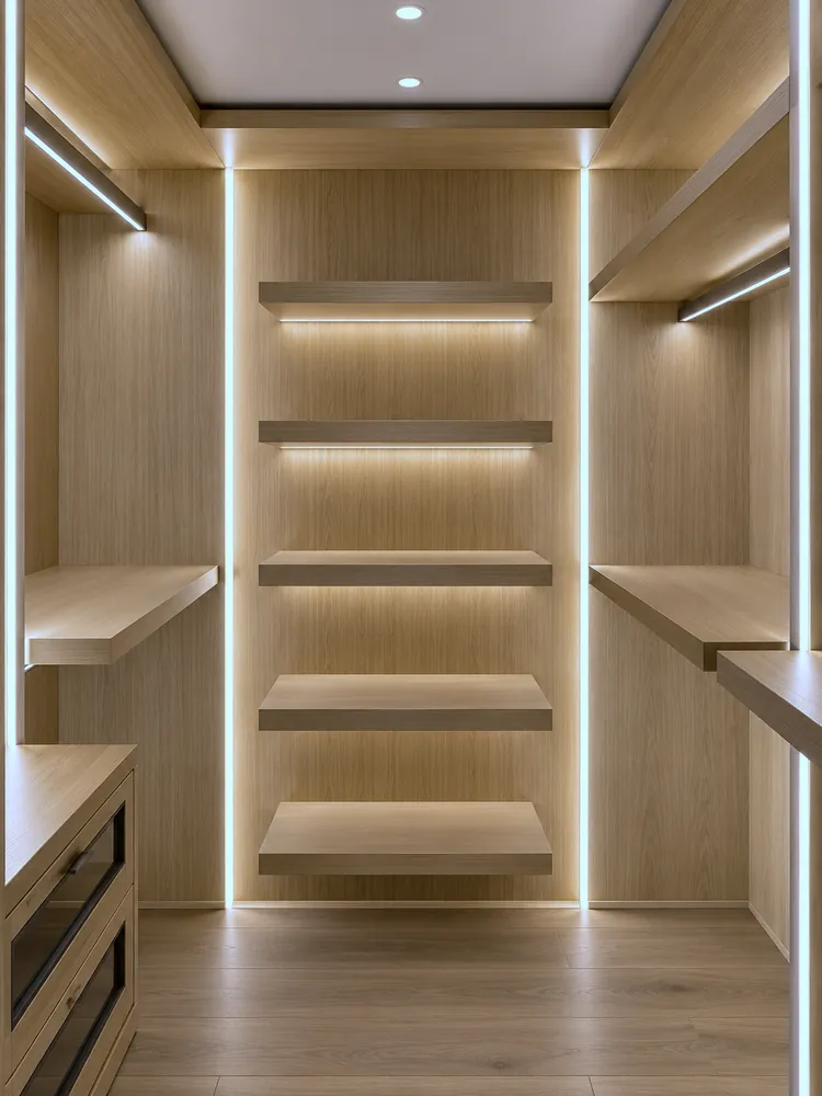 Walk-in wardrobe in oak with integrated lighting