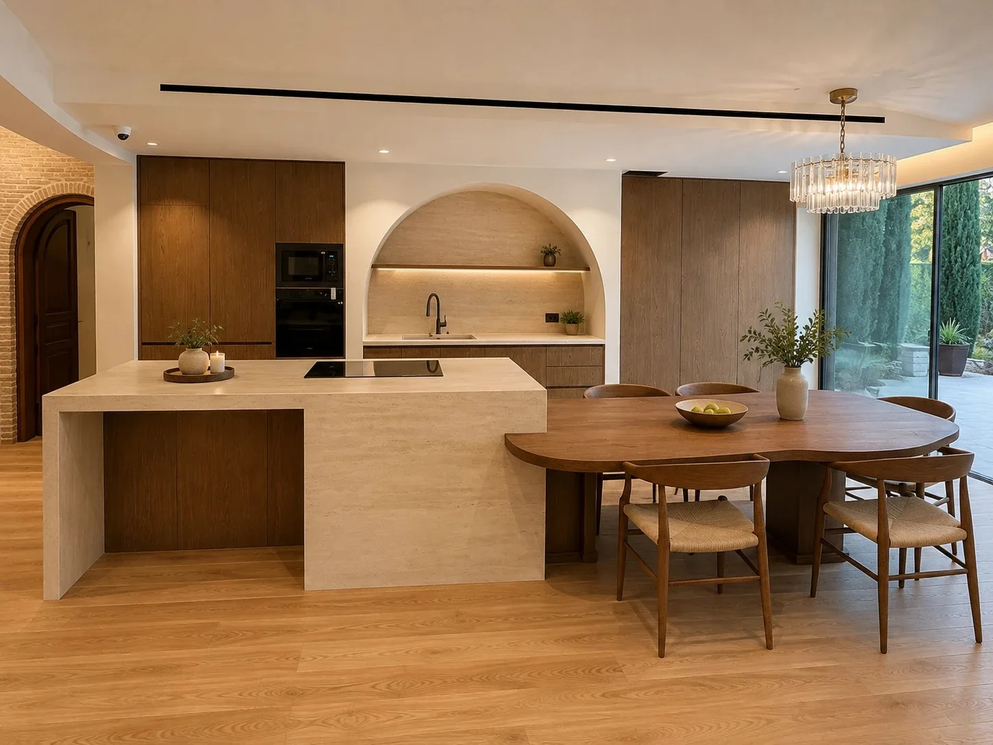 Open kitchen with a stone island, arched niche and round dining table