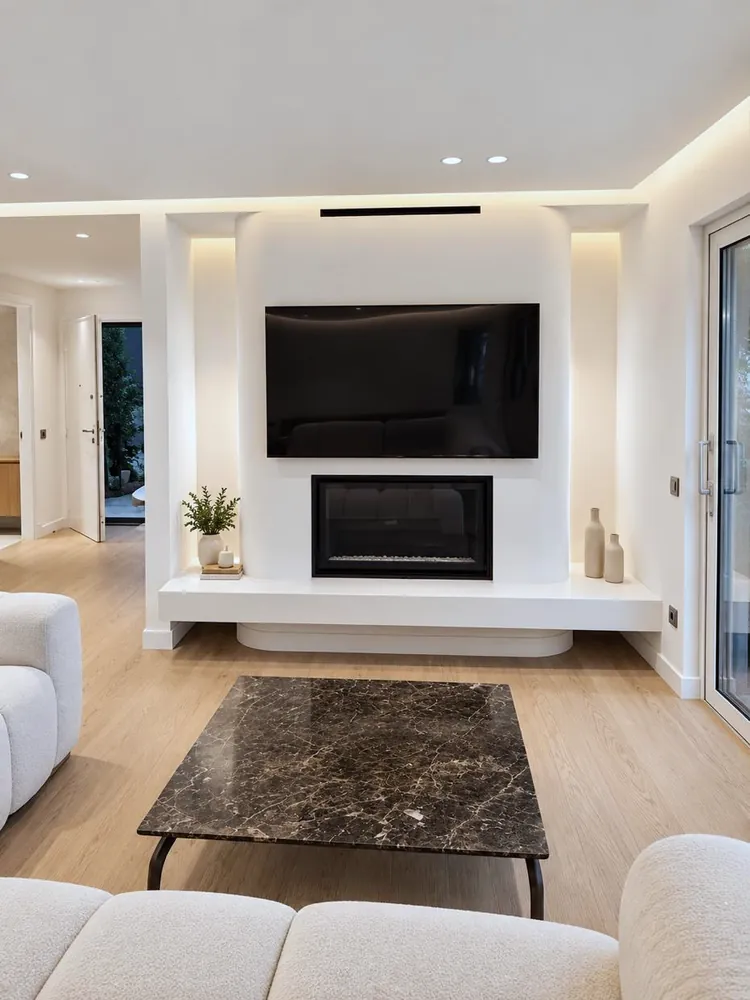 Living room with a white fireplace wall